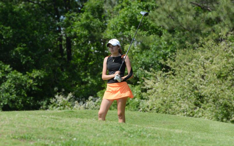 Sophomore Catherine Jackson as she watches her ball after teeing off on Hole 12 and shot a 106 at the Area 4-AA Tournament on April 29, as both will advance to state. (Photo/Benjmain London)