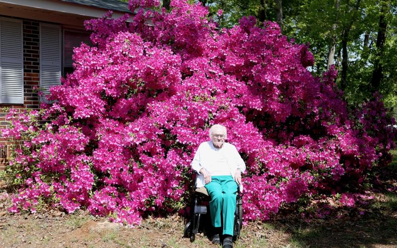 Sylvene Fleming (above and below), who turned 99 on Tuesday, sits in front of a huge azalea bush on the side of her home off of Old Highway 29 on Thursday, April 10. She planted the flowers a few years after moving there in 1956. (Photo/Rose Scoggins)