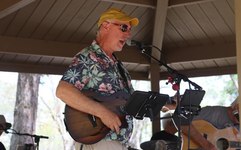 The porch band member singing and playing guitar at the 2025 Dam Dog Walk. The Porch band performed a wide variety of music for several hours during the 2025 Dam Dog Walk. (Photo/Adriana Cascio).