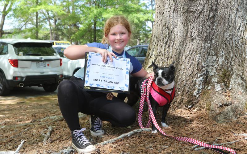 The third place winner for the best talent pageant, a Boston terrier, and her owner posing with their winner certificate at the 2025 Dam Dog Walk 2025. (Photo/Adriana Cascio)