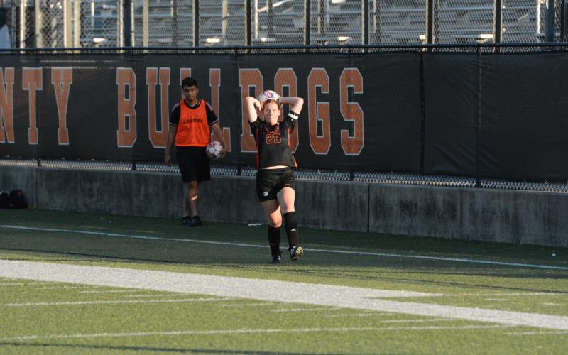 Junior defender Juliette Cason throws the ball into play earlier in the season. (Photo/Benjamin London)