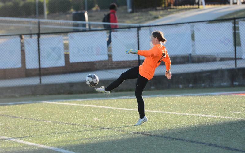 Goalkeeper Kaylin Bowers punts the ball away after a save in the 8-0 loss to Stephens County on March 21. (Photo/Benjamin London)
