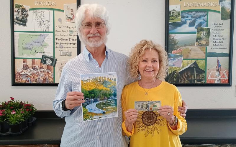 Spring 2025 Lake Living cover winner Morgan Harvill, left, is pictured with his wife, Judy. The magazine cover features a MasterCraft boat on Lake Rabun in Rabun County at the narrows around September 2024. In addition to gracing the cover of Spring 2025 Lake Living, Harvill received $100. (Photo/Megan Horn, The Clayton Tribune)