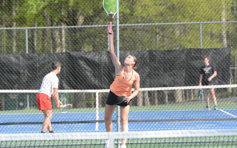 Lyla Phillips serves the ball as she picked up a 6-2, 7-5 win at No. 1 singles in the 3-2 loss to East Jackson on April 15. (Photo/Benjamin London)
