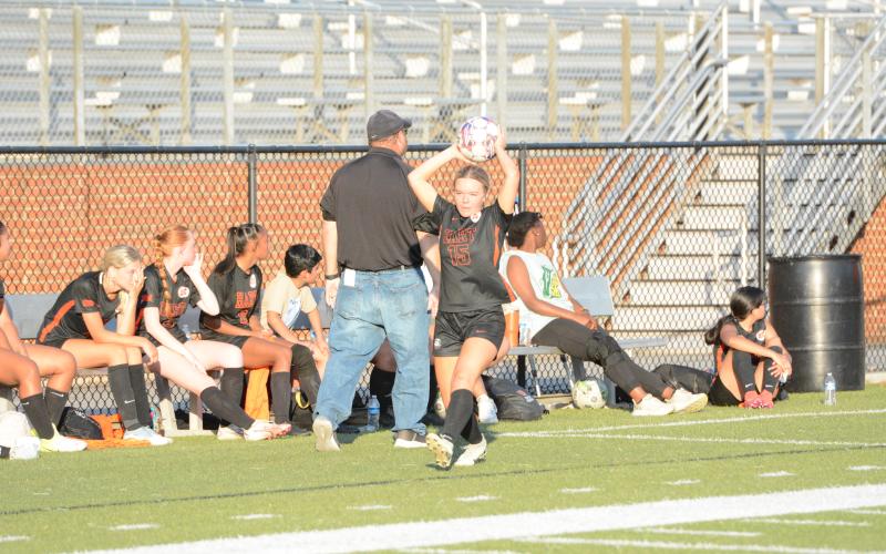 Senior defender Mackenzie Searles throws the ball into play earlier in the season. (Photo/Benjamin London)