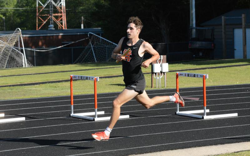 Nate Harris runs in the fourth leg of the 4x800-meter relay as he helped the Dogs place first in the event at the home meet against Westside on April 15. (Photo/Benjamin London)