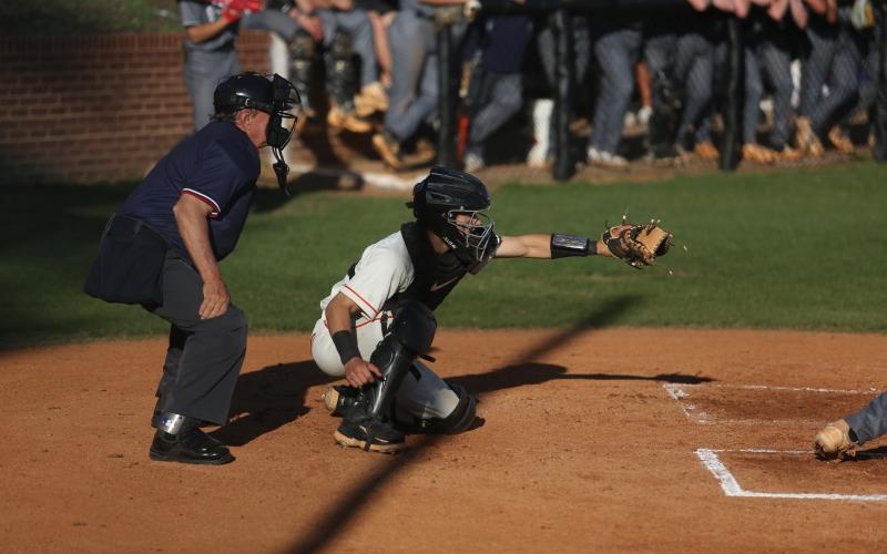 Senior catcher Pearce Mewborn awaits the pitch in the 5-4 walkoff win over East Jackson. (Photo/Rose Scoggins)