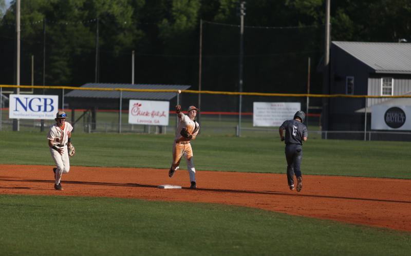 Senior infielder Riley Kesler helps tun a double play in the 5-4 win over East Jackson. (Photo/Rose Scoggins)