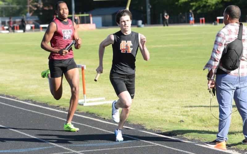 Sevyn Singleton (right) runs in the first leg of the 4x800-meter relay as he helped the Dogs place first in the event at the home meet against Westside on April 15. (Photo/Benjamin London)