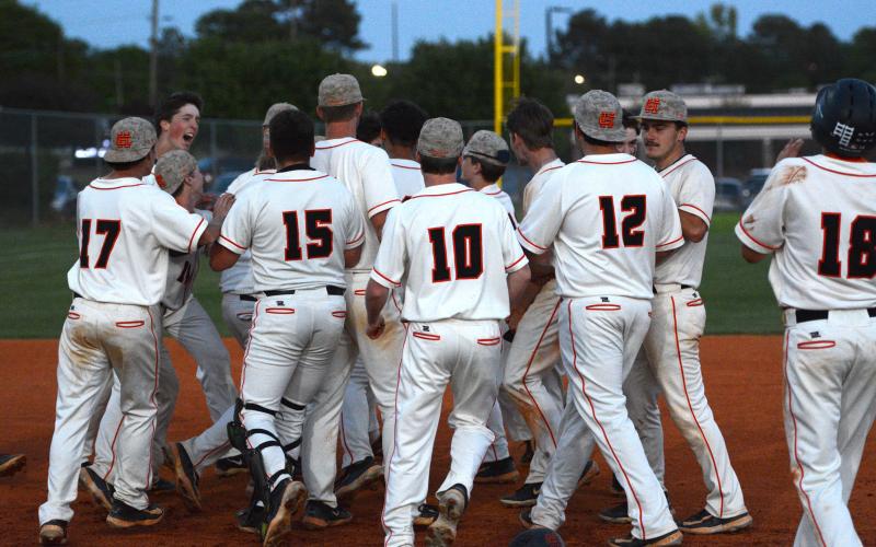 The Hart County baseball team celebrates after a 5-4 walkoff win on senior night at Saye Field on April 16. (Photo/Benjamin London)