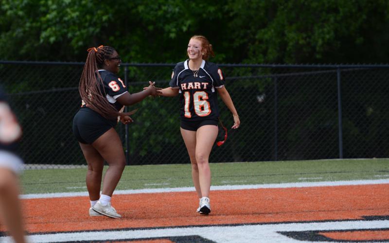 Seniors Endiya Burton (left) and Channing Segars celebrate after a touchdown in the 2025 Powderpuff game on May 7. (Photo/Benjamin London)