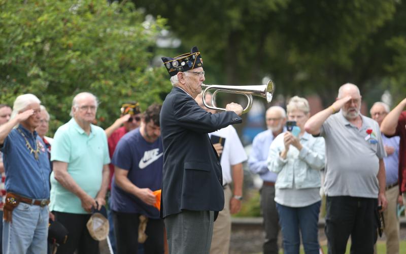 American Legion Post 109 held its annual Memorial Day ceremony Monday, May 26 at the Hart County Courthouse. Above, U.S. Air Force veteran Phil Stocks plays Taps outside the courthouse as attendees and fellow retired service men and women salute. (Photo by Rose Scoggins - Editor/Publisher)