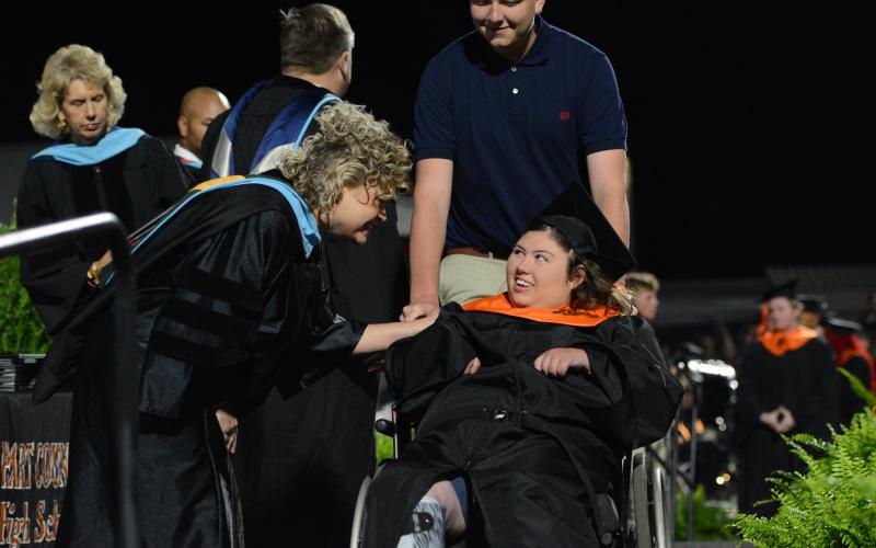 Superintendent Jennifer Carter (left) and Trinity Smith (right) exchange smiles after Smith received her diploma from Hart County High School Principal Kevin Gaines during the Hart County Charter System’s annual commencement ceremony Friday, May 23. See more photos from graduation on page 16A. (Photo/Benjamin London)
