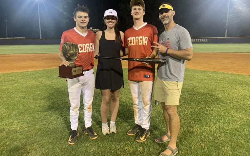 Pictured from left are Diamond Dogs’ senior infielder Pearce Mewborn with the championship trophy, Lake Hartwell FCA’s Olivia Morris, Diamond Dogs’ senior infielder and pitcher Riley Kesler with the MVP trophy and Lake Hartwell FCA’s Chad Posey. (Photo/Benjamin London)