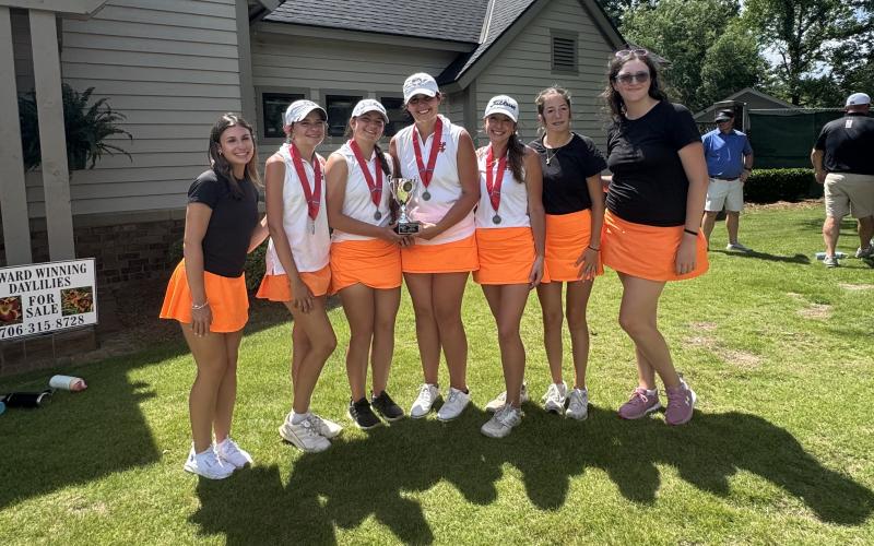 Pictured is the girls golf team with the state runner-up trophy after placing second as a team at state. (Photo submitted by HCHS Golf)
