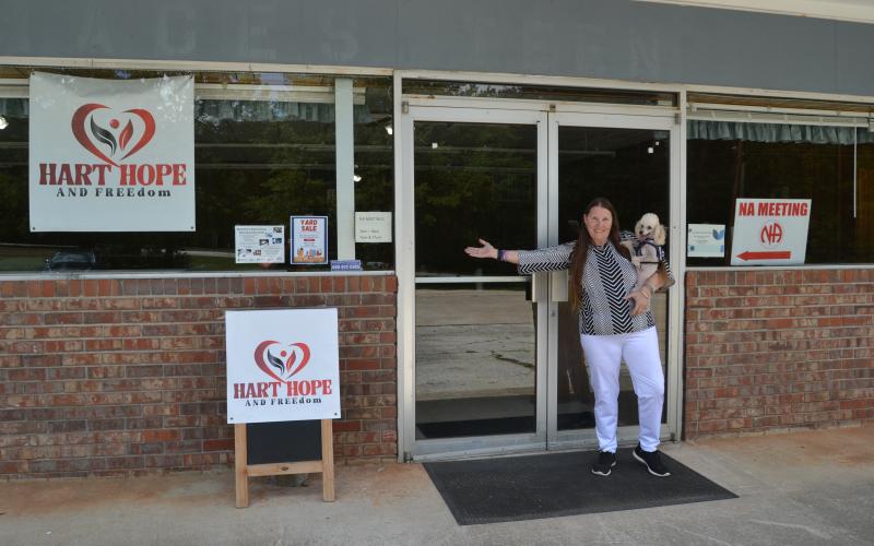 Director Leah Tolbert and Kingston, Tolbert’s toy poodle, stand in front of Hart Hope and FREEdom located at 185 Chandler Street. Kingston attends most meetings and appointments with Tolbert, offering a supportive furry friend to attendees. (Photo/Adriana Cascio)