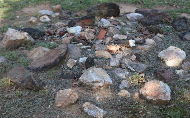 A seemingly insignificant pile of stones rests in the historic Harmony Grove Baptist Church Cemetery. Originally scattered across the field, these stones represented grave markers for slaves, and once moved, dozens of burial sites were unidentified. (Photo/Adriana Cascio)