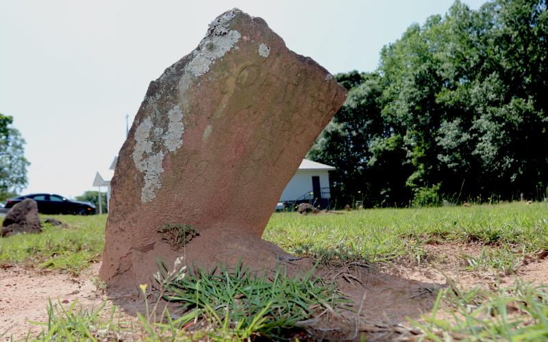 An etched stone marks the burial site of a slave in Harmony Grove Cemetery. Many stones were left unmarked, but few have names and dates etched into the stone dating back to the 1700s. (Photo/Adriana Cascio)