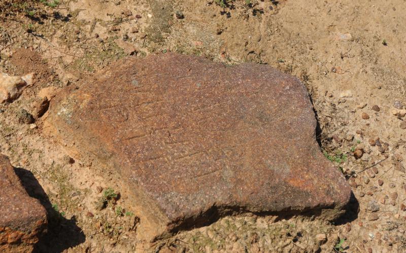 An etched stone marks the burial site of a slave in Harmony Grove Cemetery. Many stones were left unmarked, but few have names and dates etched into the stone dating back to the 1700s. (Photo/Adriana Cascio)