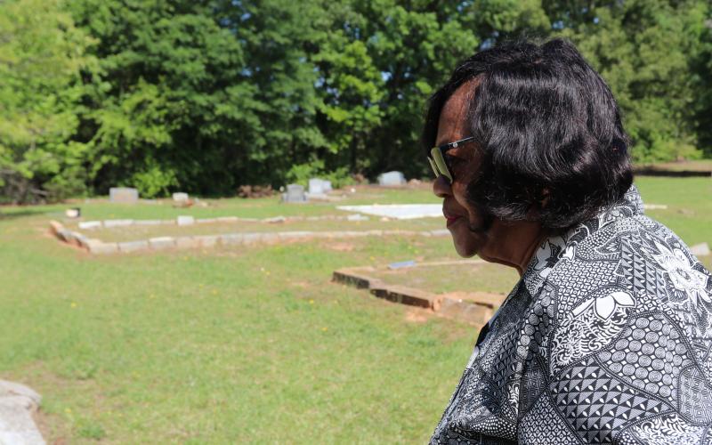 Diane Merritt, owner of surrounding land and congregant of Harmony Grove Missionary Baptist Church, looks over the historic Harmony Grove Baptist Church Cemetery. The land has been passed down through generations since Ervin Merritt, Merritt’s great-grandfather and former slave, inherited over 600 acres from the Bowers family. (Photo/Adriana Cascio)