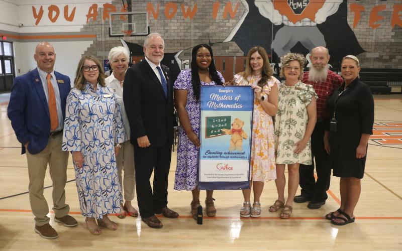 pictured are Mewborn, Pierce, Cleary, Woods, HES Principal Ashley McNeil, HES Assistant Principal Andrea Gibbs, Carter, Dowell and Bennett. (Photo/Grayson Williams)