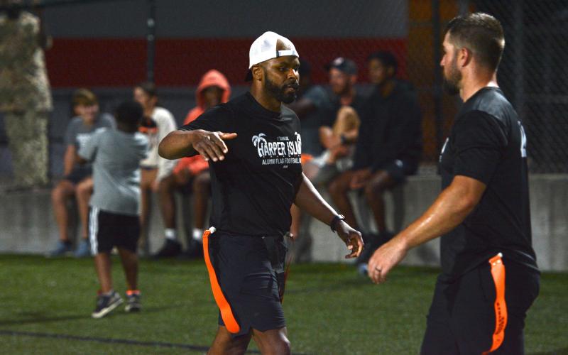 Kendrick Harper (left) celebrates with a teammate after scoring his second receiving touchdown in the 39-35 win over Team Odd in the Harper Island Alumni Game.  (Photo/Benjamin London)