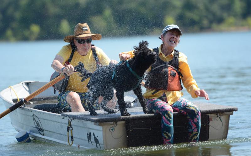 Jato, a 3-year-old male Junior PWD from Asheville, North Carolina, shakes off water on Allen Reindorf (left) and Morgan Jennings (right) after performing tricks during the water trials. (Photo/Adriana Cascio)