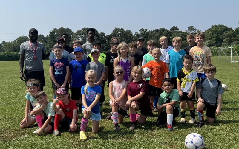 The Bell Family YMCA of Hartwell hosted more than 35 campers during their annual FUNdamental soccer camp June 2-6. Campers learned the fundamentals of soccer -- passing, dribbling and shooting, while others grew a love for the game. Pictured is all of the campers who attended with YMCA’s sports director Kerv Augustin (pictured on the back row to the left). (Photo/Adriana Cascio)