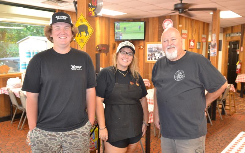Three generations of the Beck family have worked at Backstreet Bar-B-Q over the last 25 years, including left to right, Kain Norris, son of co-owner Kayla Segars, Segars and co-owner Bob Beck. Segars is the daughter of former co-owner Frankie Beck, Bob’s brother. (Photo/Adriana Cascio)