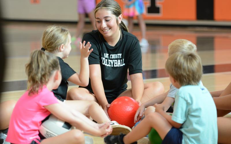 Rising junior Josee Fleming (middle) coaches her group during the annual Kids Volleyball Camp. (Photo/Benjamin London)
