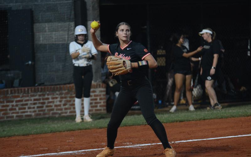Madi Bennett fields a blunt before throwing the runner out at first during a fast-pitch game in 2024. (Photo/Benjamin London)