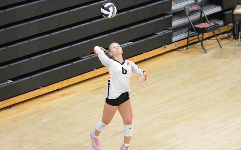 Sophomore Addison Coles serves the ball into play during the 26-24, 25-23 win over the Lady Devils Aug. 12. (Photo by London)