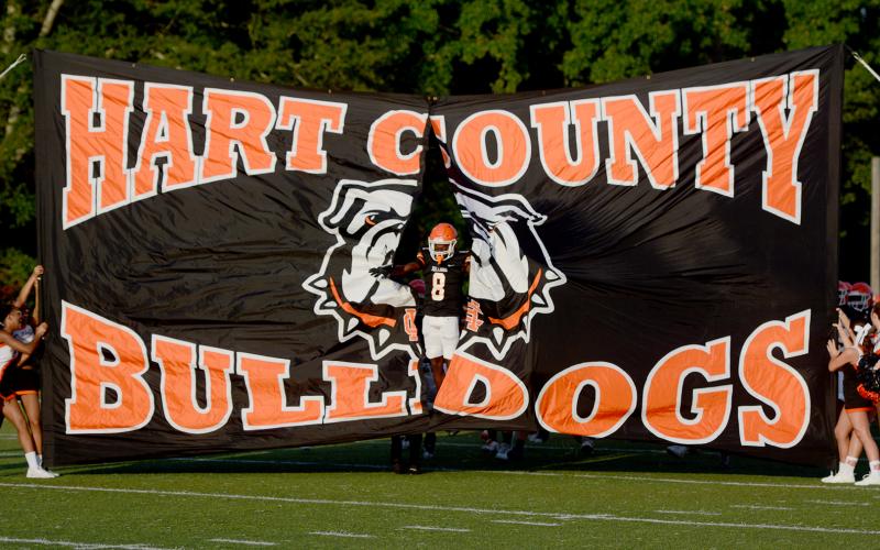 Senior CJ Cowins led the Dogs through the spirit banner to kickoff the evening. See full coverage of Friday’s scrimmage in our sports section. (Photo/Benjamin London)
