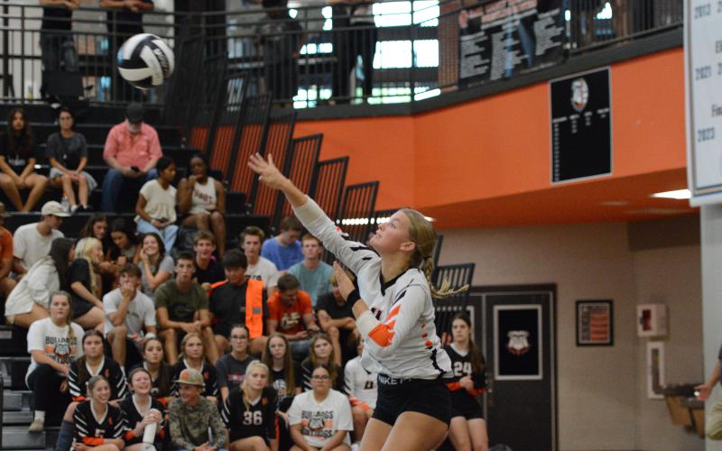 Senior libero Erin Miller serves the ball into play in the 3-0 win over Athens Christian Aug. 18. (Photo by Benjamin London)