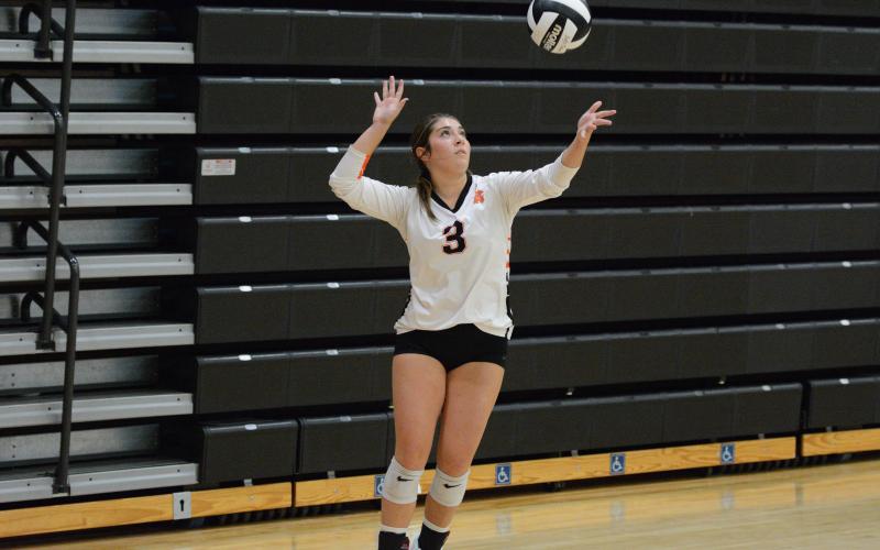 Junior setter Josee Fleming serves the ball into play during the match with the Lady Devils of Elbert County. (Photo by London)