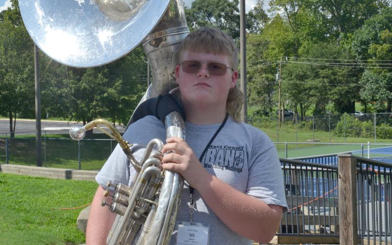 Sousaphonist Kabil Carey holds his sousaphone on his shoulder with pride after being named member of the week for this week’s High Notes series. Carey was selected for his great attitude and dedication to learning during his first marching season. (Photo by Adriana Cascio)