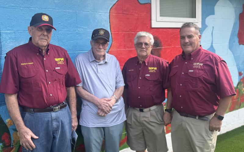 VFW Post 8076 members (L-R) Charles Howard, Jack Eagan, Herb Hicks and Eric McAllister pose in front of the “Buddy Poppy” mural on the renovated VFW building, located at 173 Ack Powell Road. Most renovations were done by VFW members, volunteers and help from local organizations, such as Golden K, Turner Concrete and Dennis Holland Heating Air and Electrical. (Photo by Adriana Cascio)