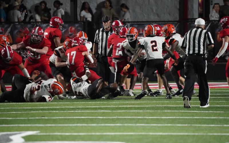A host of Bulldog defenders making the tackle on the Red Raiders quarterback. (Photo by Ric Williams)