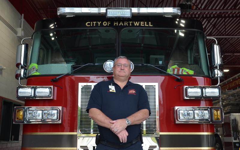 Fire Chief Alan Daniel poses in front of a fire truck at the Hartwell Fire Department, located at 456 E. Howell St., on Tuesday. Daniel is recognized this week as a hero of Hart County for his 41 years of service to the community. (Photo by Adriana Cascio)