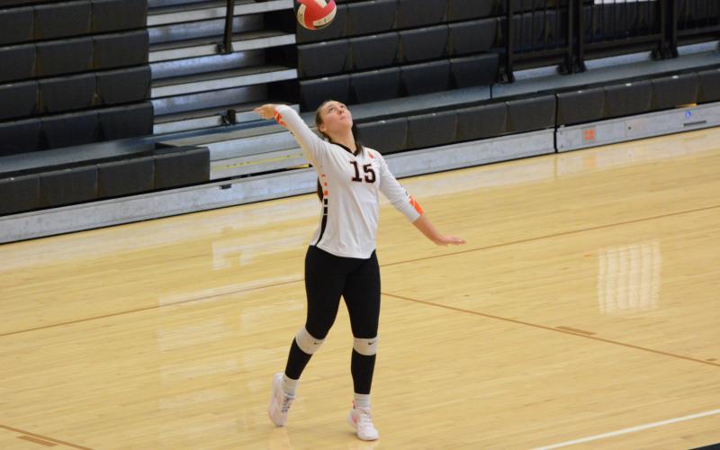 Senior middle Ashlyn Wicker serves the ball into play during their 2-0 win on the road against Prince Avenue Sept. 18. (Photo by Benjamin London)