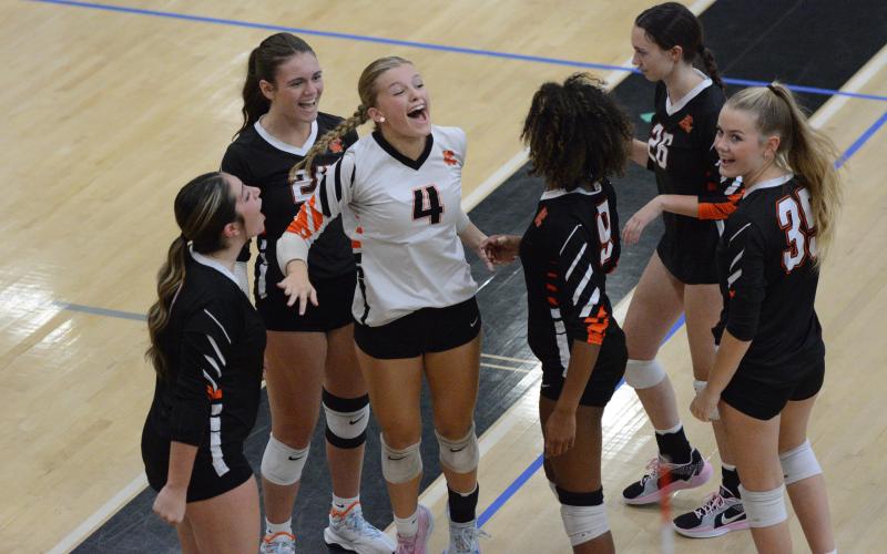 The Volley Dogs celebrate after picking up the 2-0 win (25-18 and 25-18) over the defending AAA state champion, the Lady Dragons of Jefferson Sept. 4. (Photo by Benjamin London)
