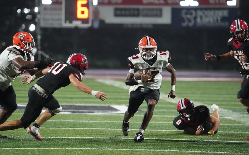 Junior quarterback Kurston Curry scores on the quarterback keeper from 32 yards out in the 24-14 loss to Flowery Branch Sept. 5. (Photo by Ric Williams)