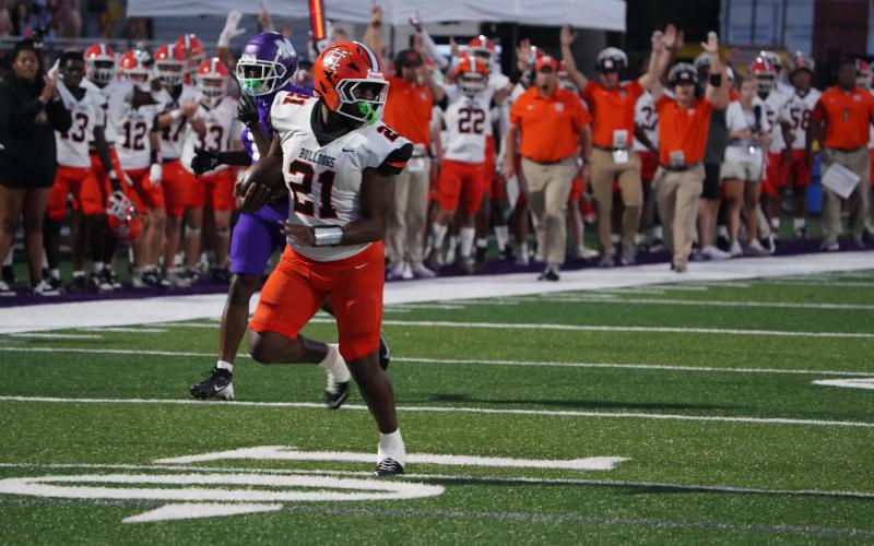 Junior running back Faustino Rangel breaks free for a 32 yard touchdown run on the opening drive during the 25-13 loss to the Purple Hurricanes of Monroe Area. (Photo by Ric Williams)