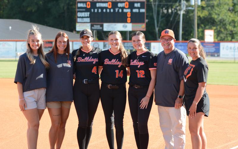 Pictured from left is assistant coach Lauren Brown, assistant coach Kalyn Jinks, senior infielder Madi Bennett, senior pitcher and outfielder Emma Mitchell, senior infielder Kinsley Duncan, head coach Gerald Gates and HCMS head coach Meredith Dunn during senior night, Sept. 22, against Banks County. (Photo by Benjamin London)