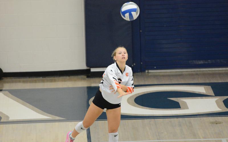 Sophomore defensive specialist Addison Coles serving the ball into play in the 2-0 win over East Jackson Sept. 25. (Photo by Benjamin London)