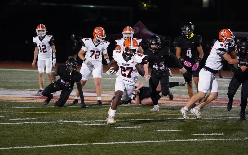 Freshman running back Ian Sheppard (27) breaks free for a late 44 yard touchdown run in the 54-10 loss to the No. 1 ranked Lions of Hebron Christian Oct. 3. (Photo by Ric Williams)