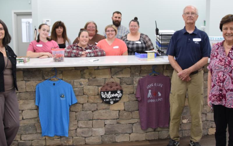 The staff at the Northeast Georgia Animal Shelter – pictured with board members Michelle Branton, John McGarity and Pam Stone – stand in the lobby of the new adoption building. The staff is available to help those looking to adopt a new dog or cat. (Photo by Shane Scoggins)