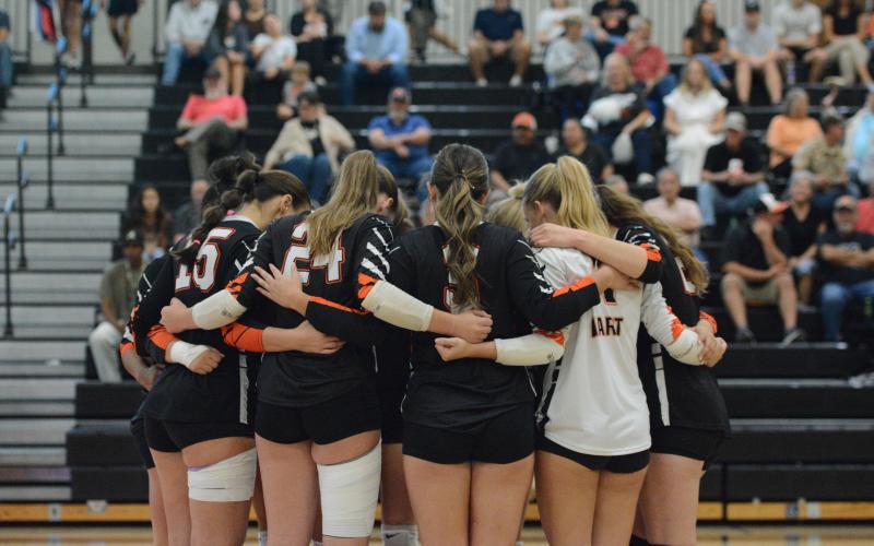 The Volley Dogs huddle up to pray before a match earlier in the season against A.R. Johnson of Augusta Oct. 14. (Photo by Benjamin London)