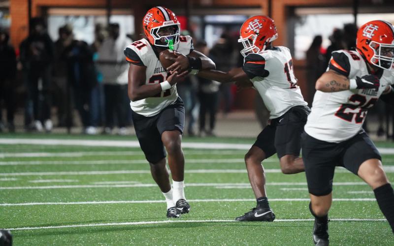 Photo by Ric Williams Junior quarterback Kurston Curry hands the ball off to junior running back Faustino Rangel who rushed for just shy of 200 yards and scored three rushing touchdowns in the 31-20 loss to Appling County Nov. 14.