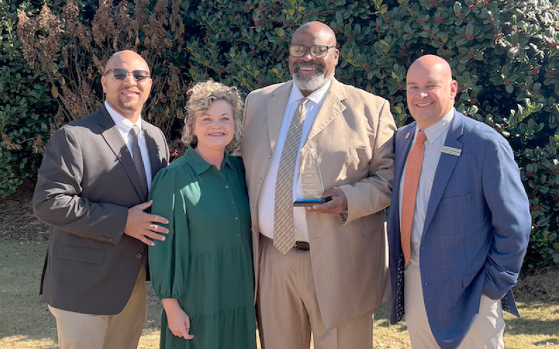 Pictured (L-R) are Hart College and Career Academy CEO Steve Burton, Superintendent Jennifer Carter, Coach William DeVane and Associate Superintendent Brooks Mewborn after Coach DeVane received the 2025 Pioneer in Education award.
